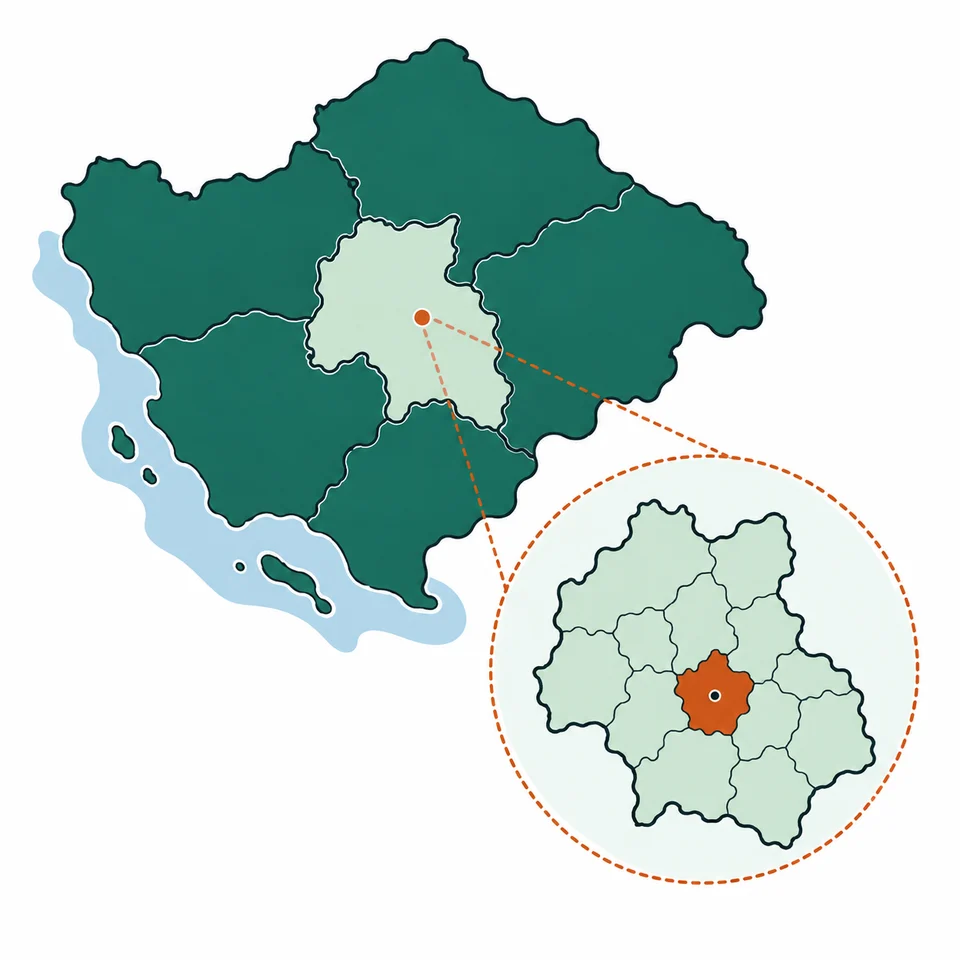 Territorio esquemático dividido en regiones, con una región ampliada que contiene divisiones locales.